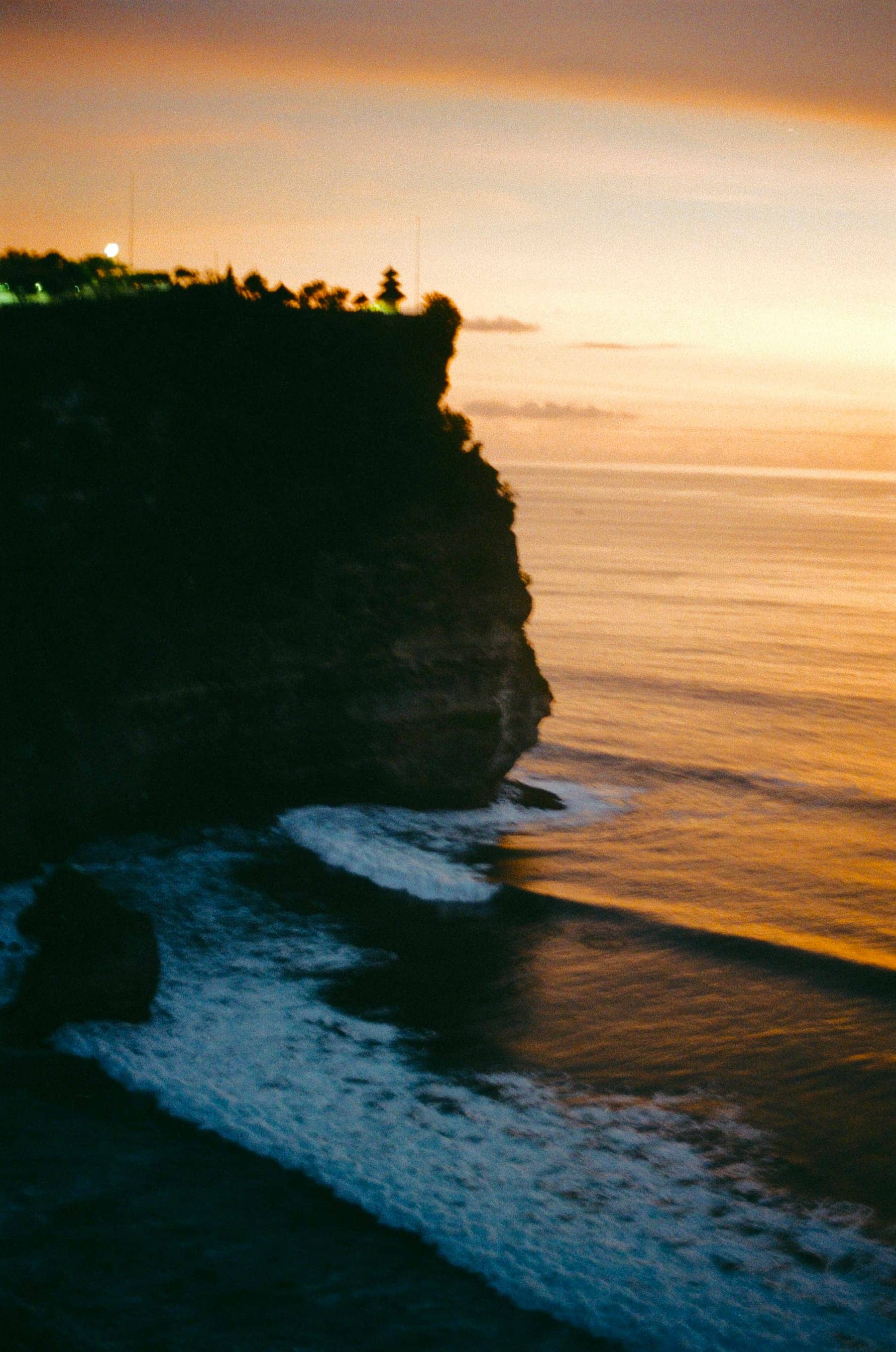Uluwatu temple cliff above the Indian Ocean at sunset, Bali